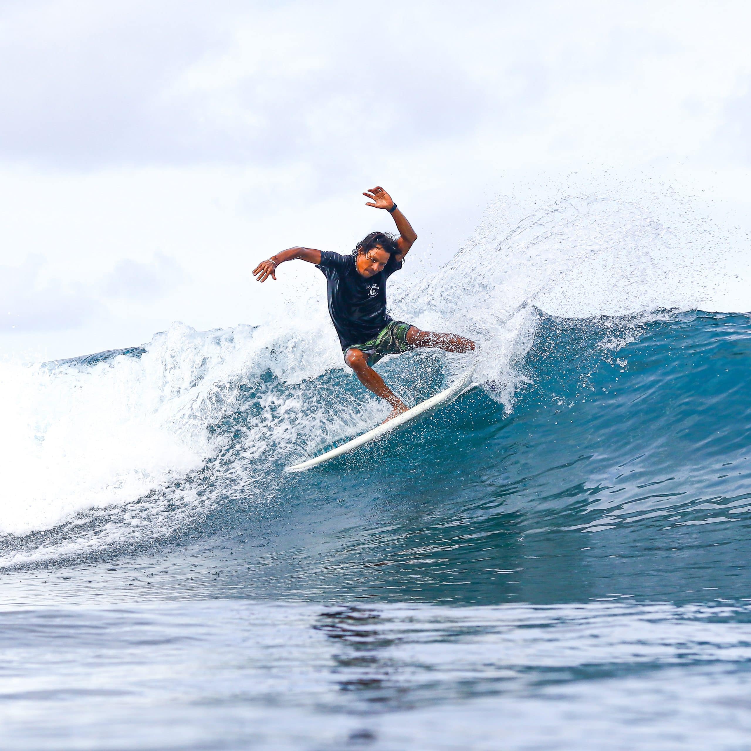 Photo of Scotty, an instructor at Padang Padang Surf Camp, surfing.