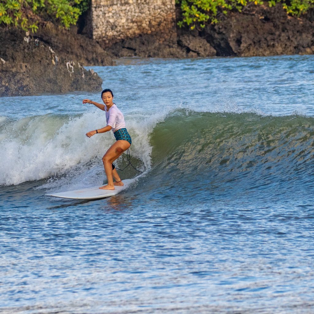 Surfer riding a wave at Muaya