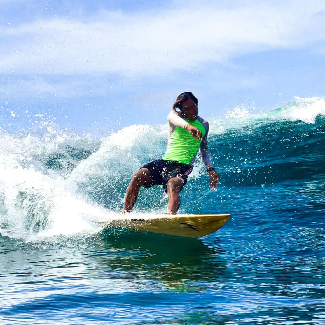 Photo of Jery, an instructor at Padang Padang Surf Camp surfing.