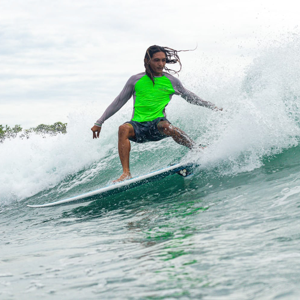 Photo of Samy, an instructor at Padang Padang Surf Camp surfing.