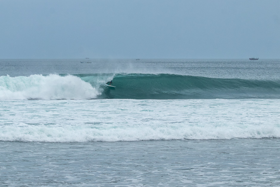 Surfer riding a long barrel at Balangan.