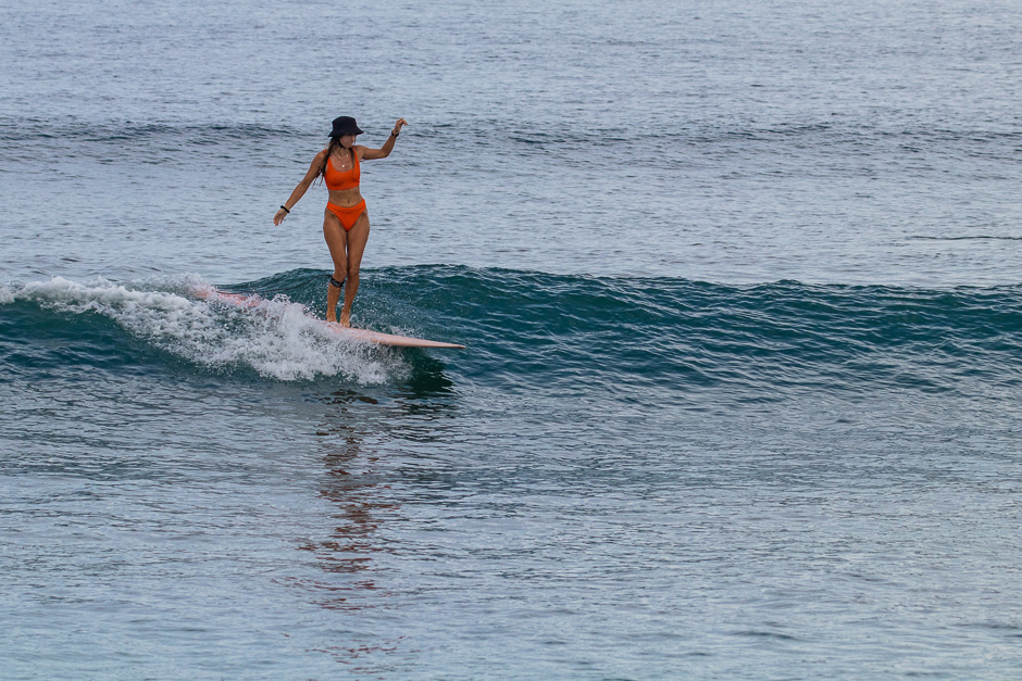 Longboarder surfing a wave at Balangan.