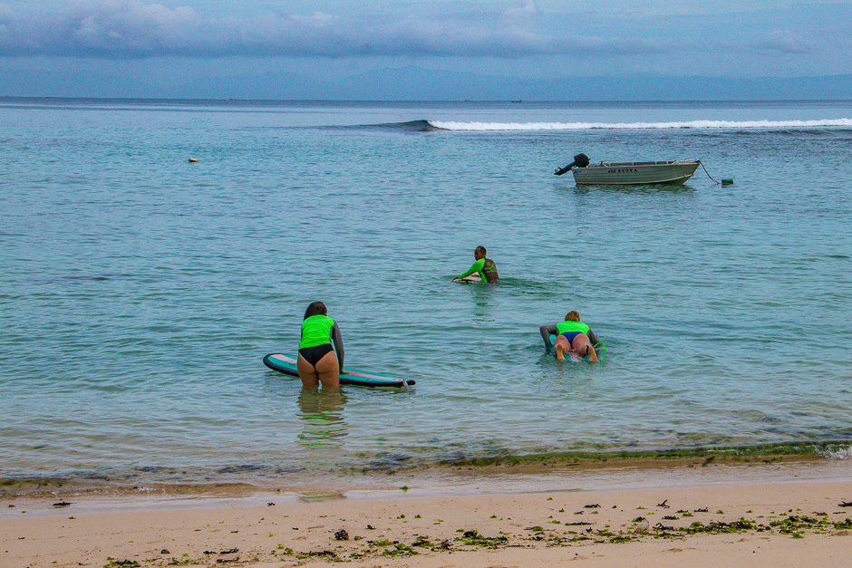 Surfers paddling out into the lineup at Padang.