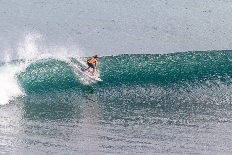 Surfer riding a small day at Impossibles.