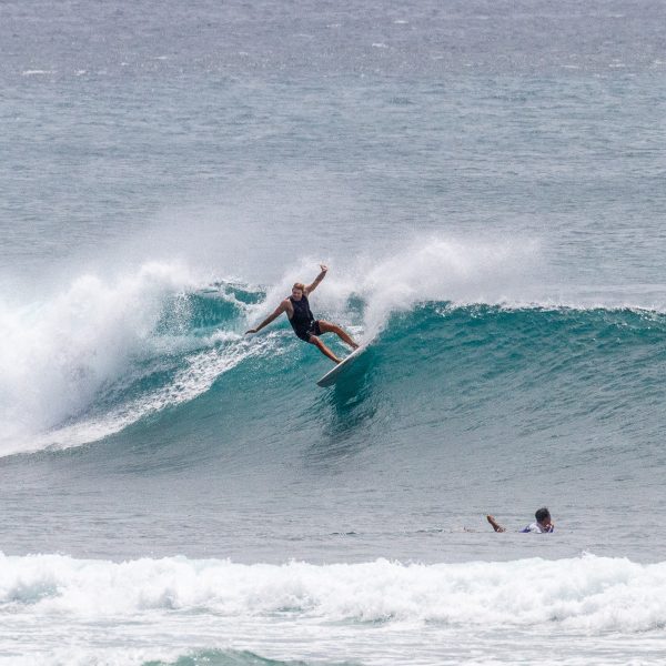 Surfer riding a wave at Pandawa.