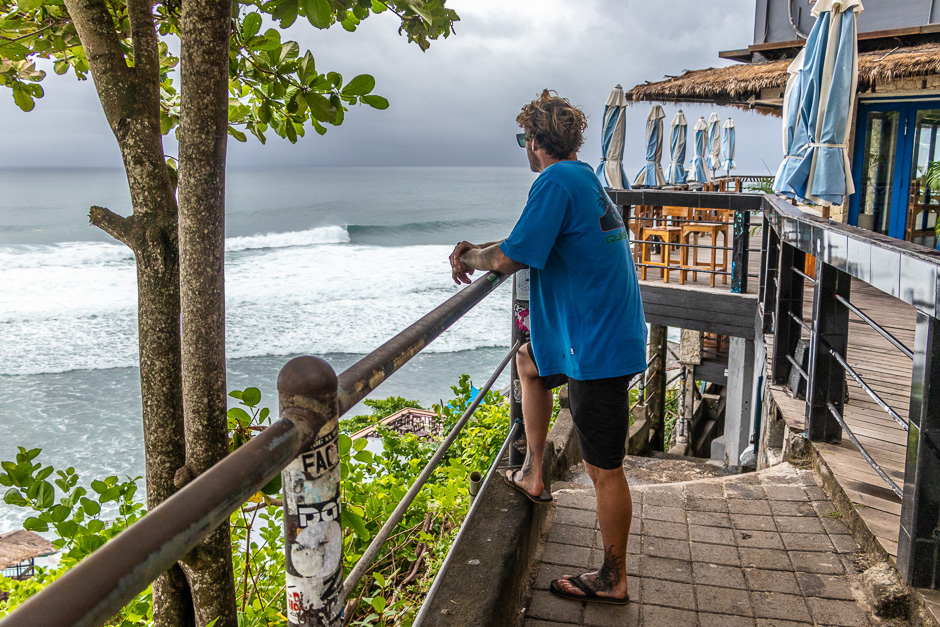 Surfer observing the wave at Uluwatu.