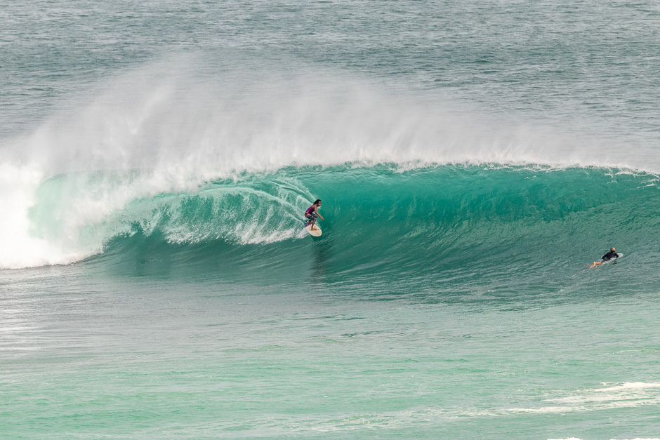 Surfer riding a barrel at Padang Lefts