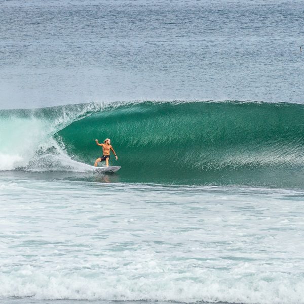 Surfer riding a barrel at Bingin.