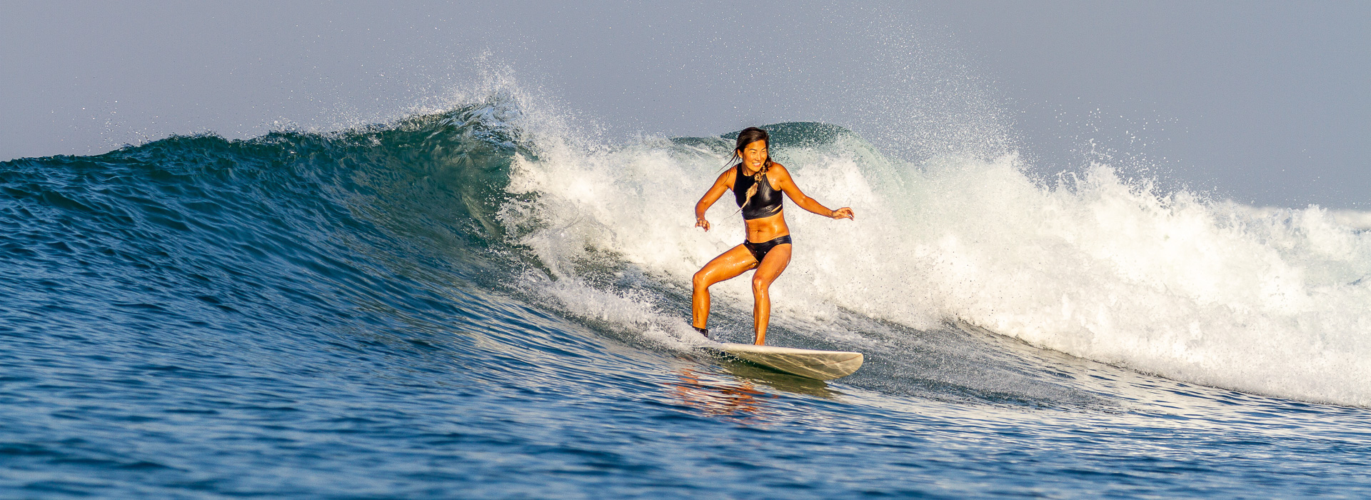 A girl riding a wave at Toro-Toro