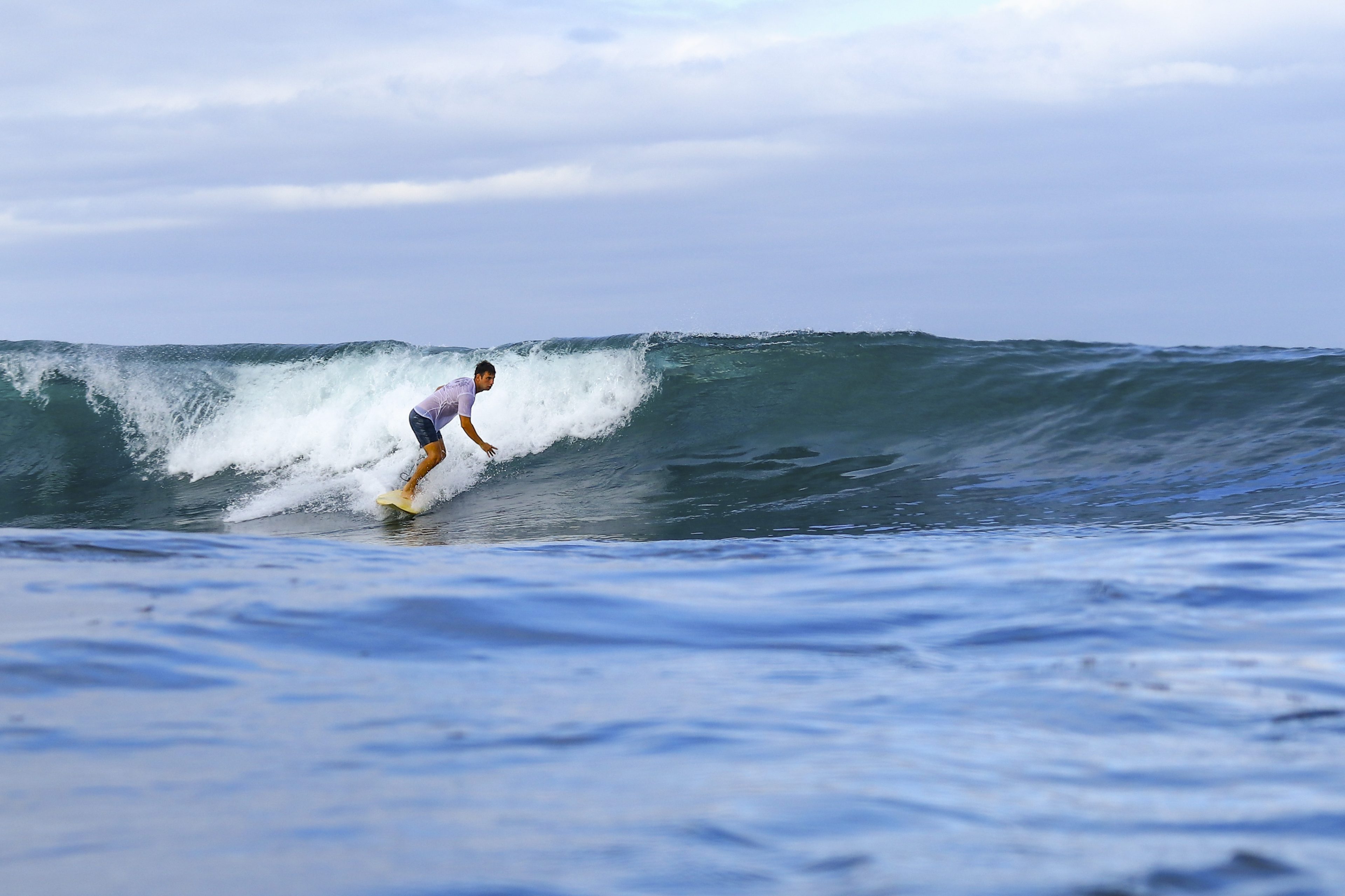 Surfer riding a wave at Middle Reef.