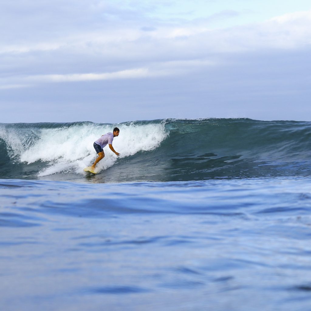 Surfer riding a wave at Middle Reef.