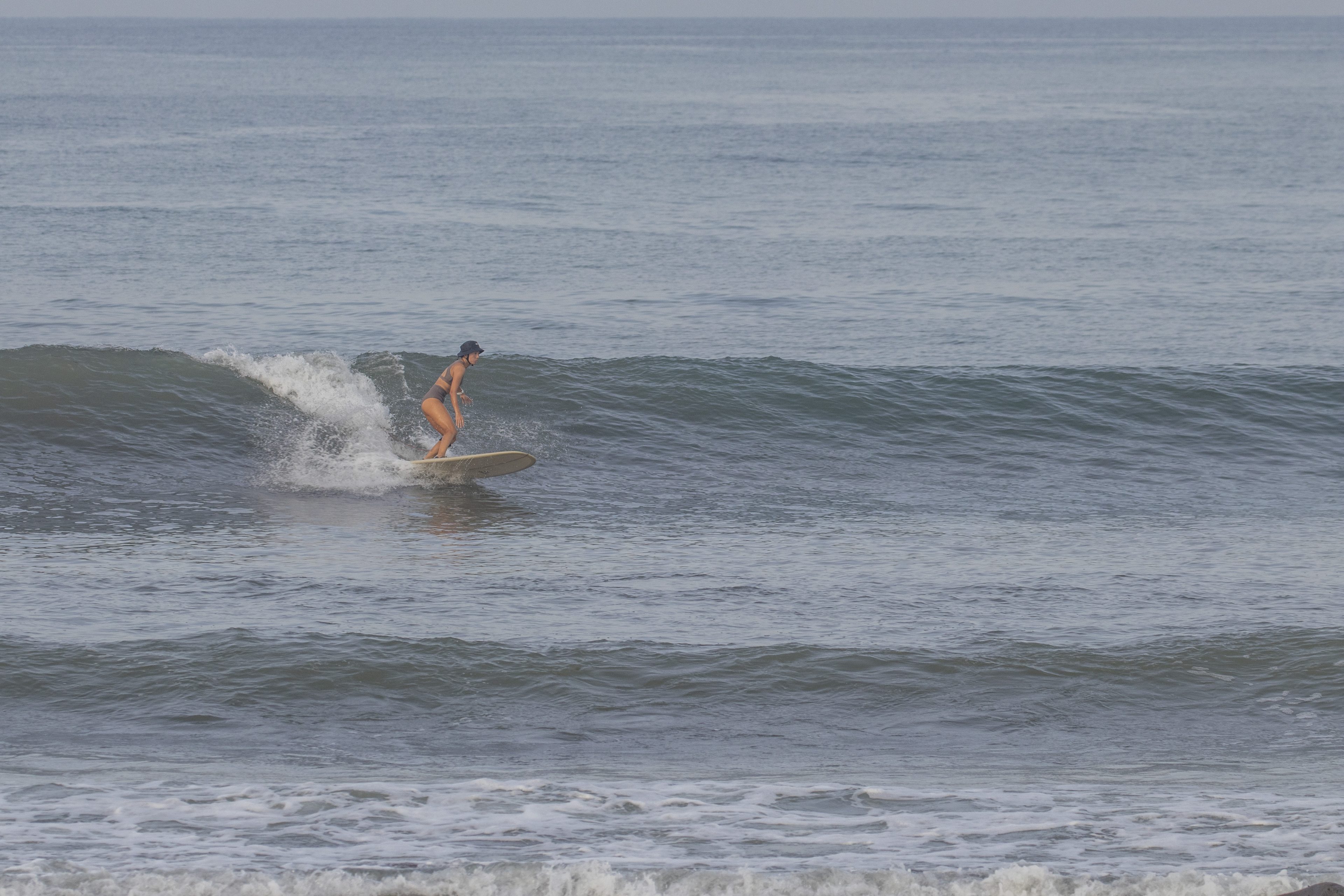 A longboarder riding a wave at Medewi.