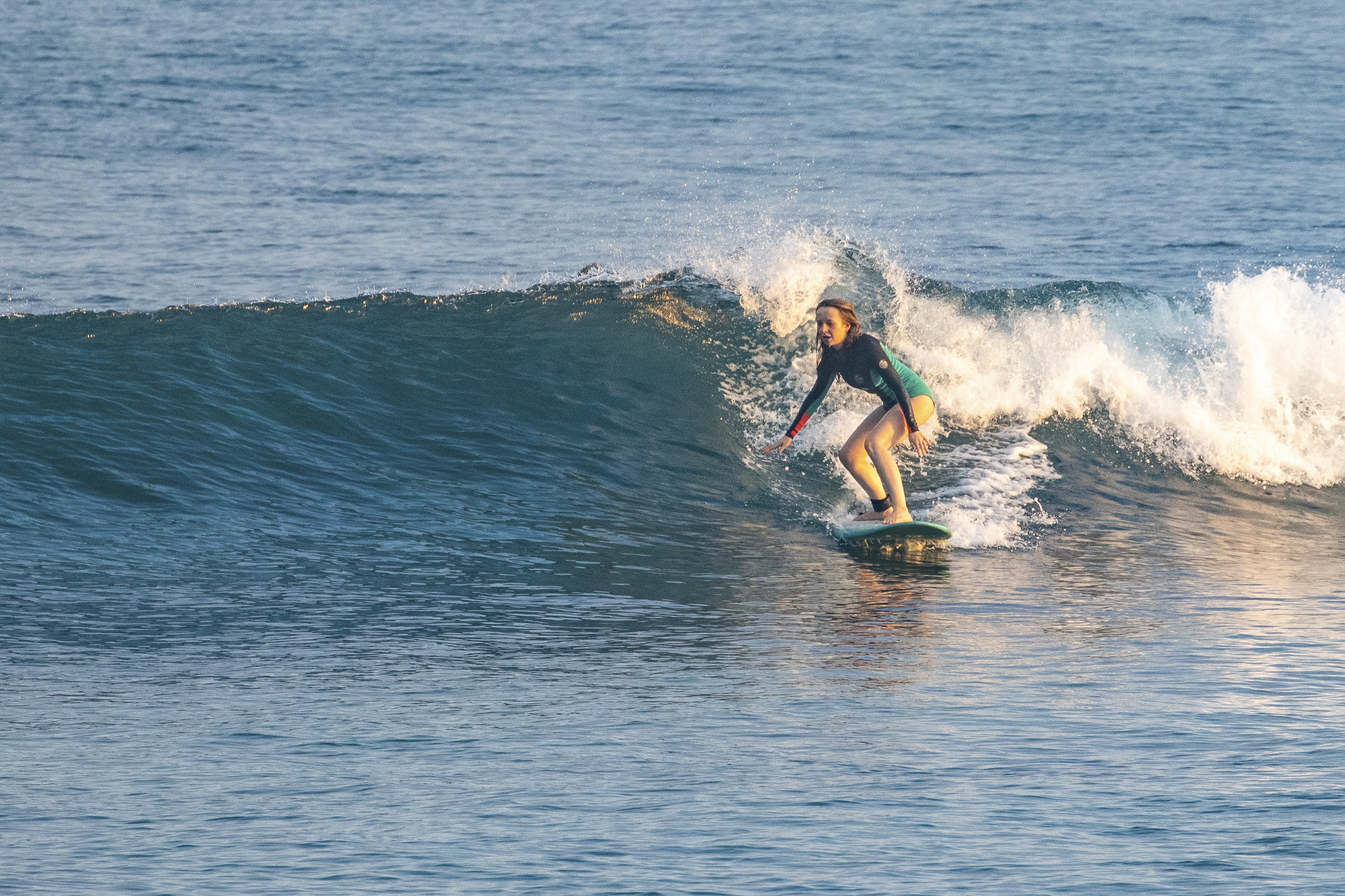 Surfer riding a wave at Padang Padang