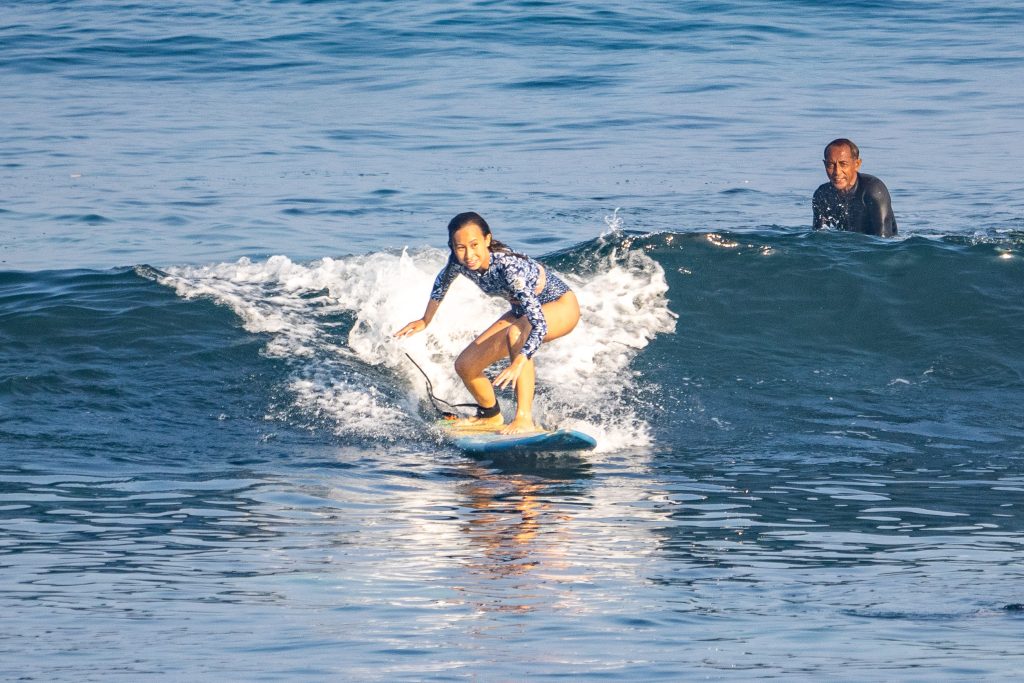 Beginner surfer riding a wave at Baby Padang