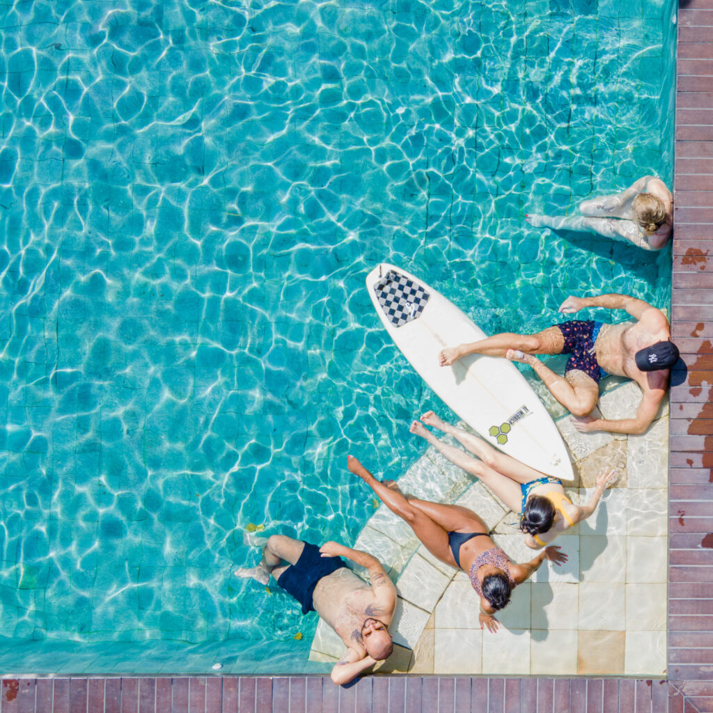 Group enjoying the pool at the surf camp