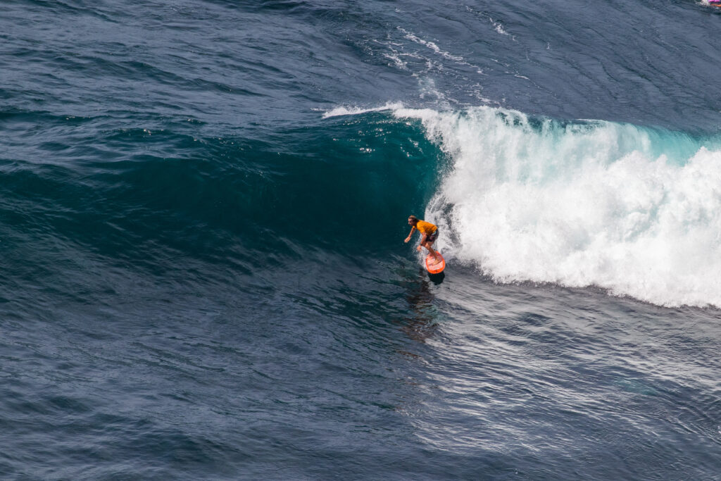 Surfer walking the beach at Nyang Nyang