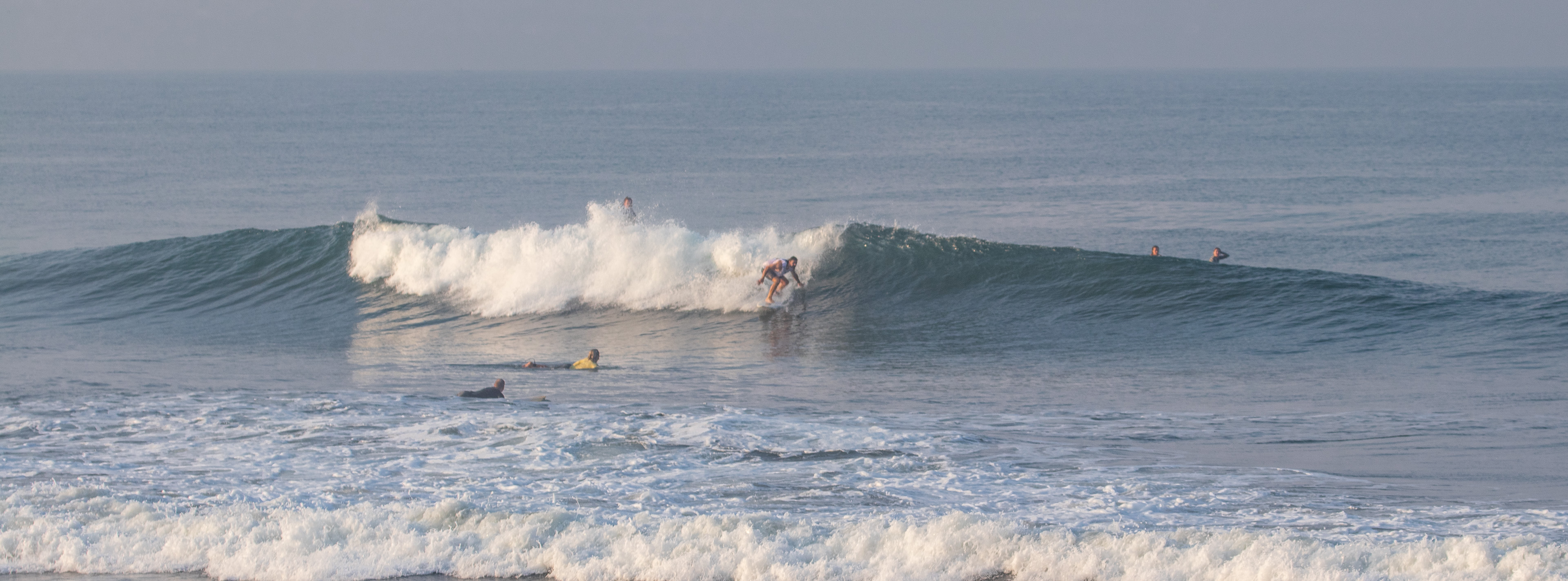 Surfer riding a wave at The Peak at Berawa
