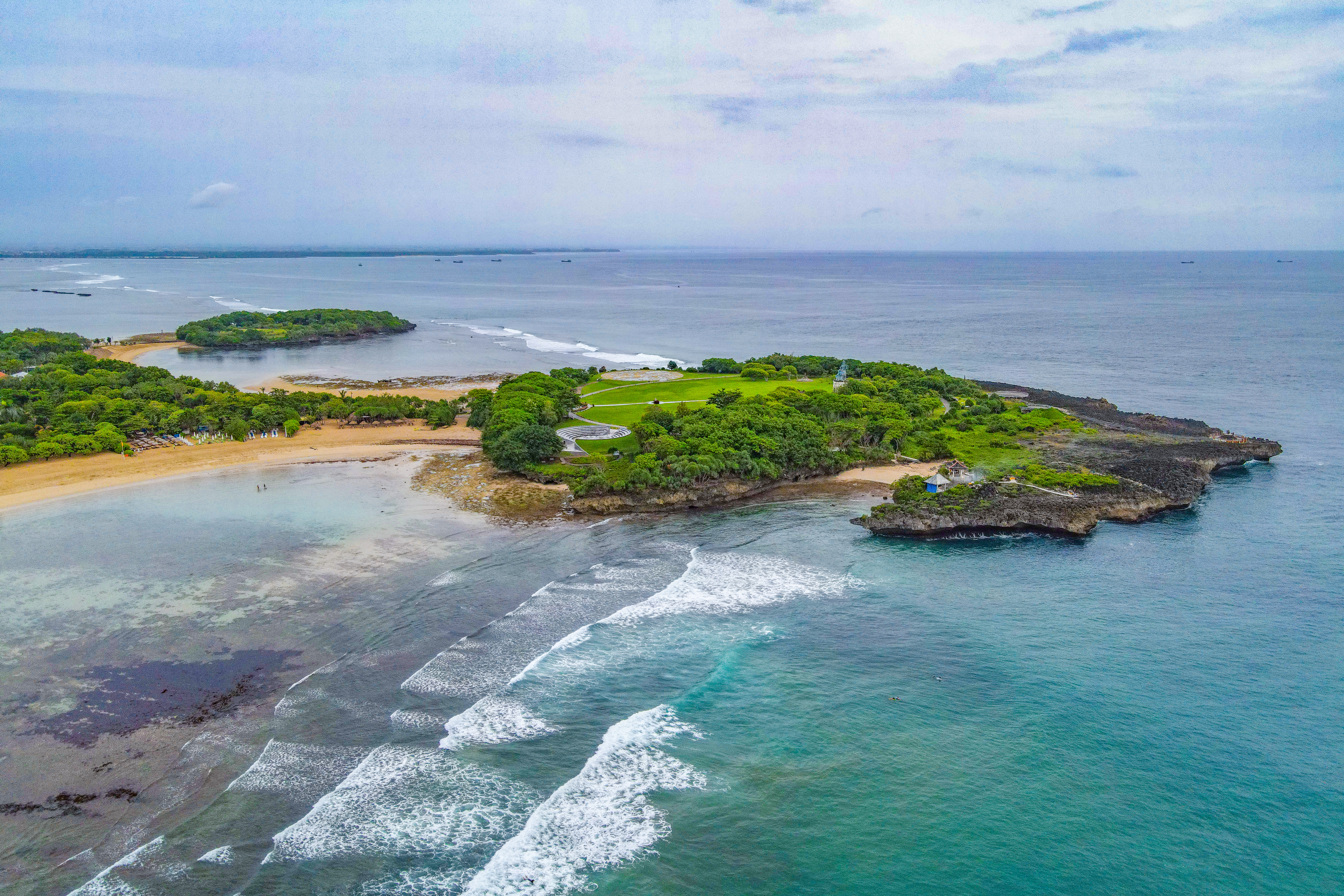 Drone shot showing Nusa Dua's two islands and the surf break at Blackstone. 