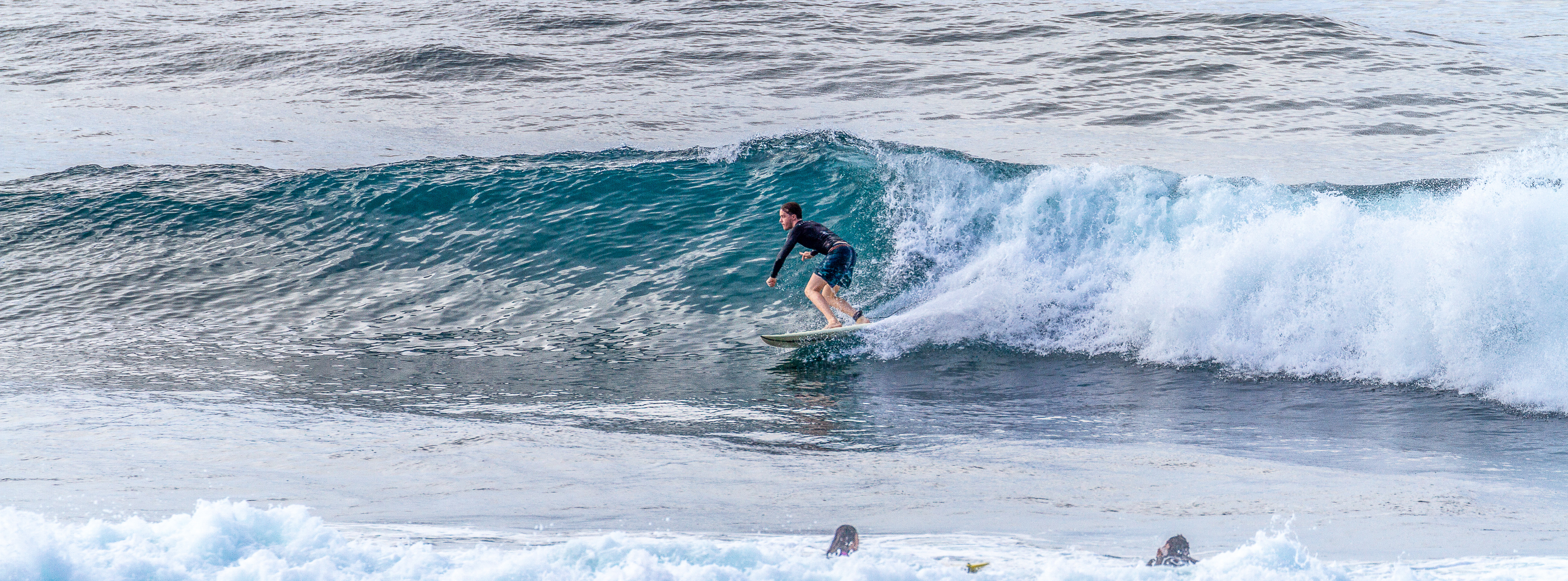 Surfer on a wave at Gunung Payung.