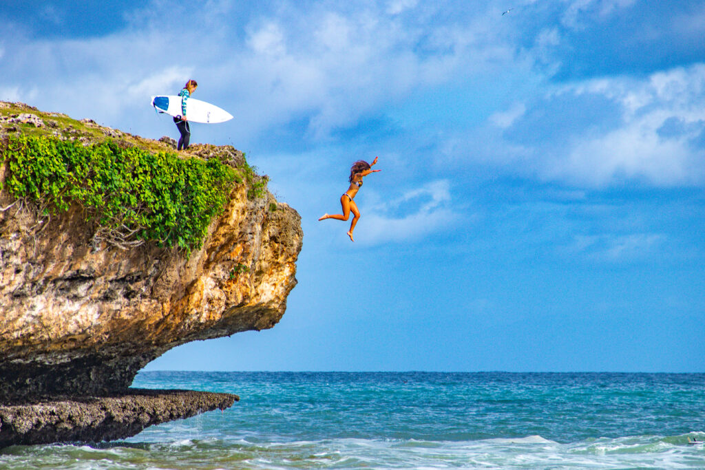 Surfer jumping into the lineup at Honeymoon.