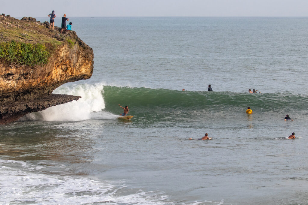 Local surfer riding a lined-up wave at Honeymoon.