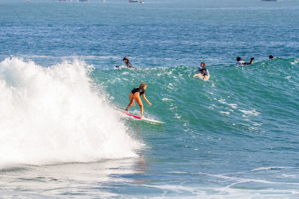 Surfer riding a wave at the intermediate peak of Honeymoon