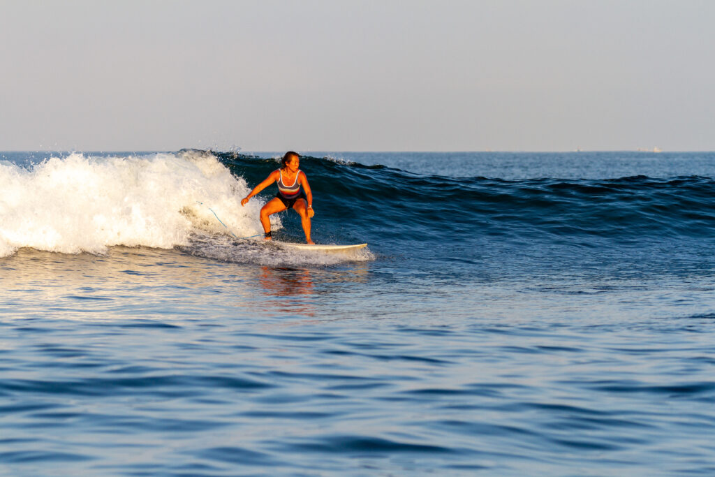 Surfer riding a left wave at Middle Reef.