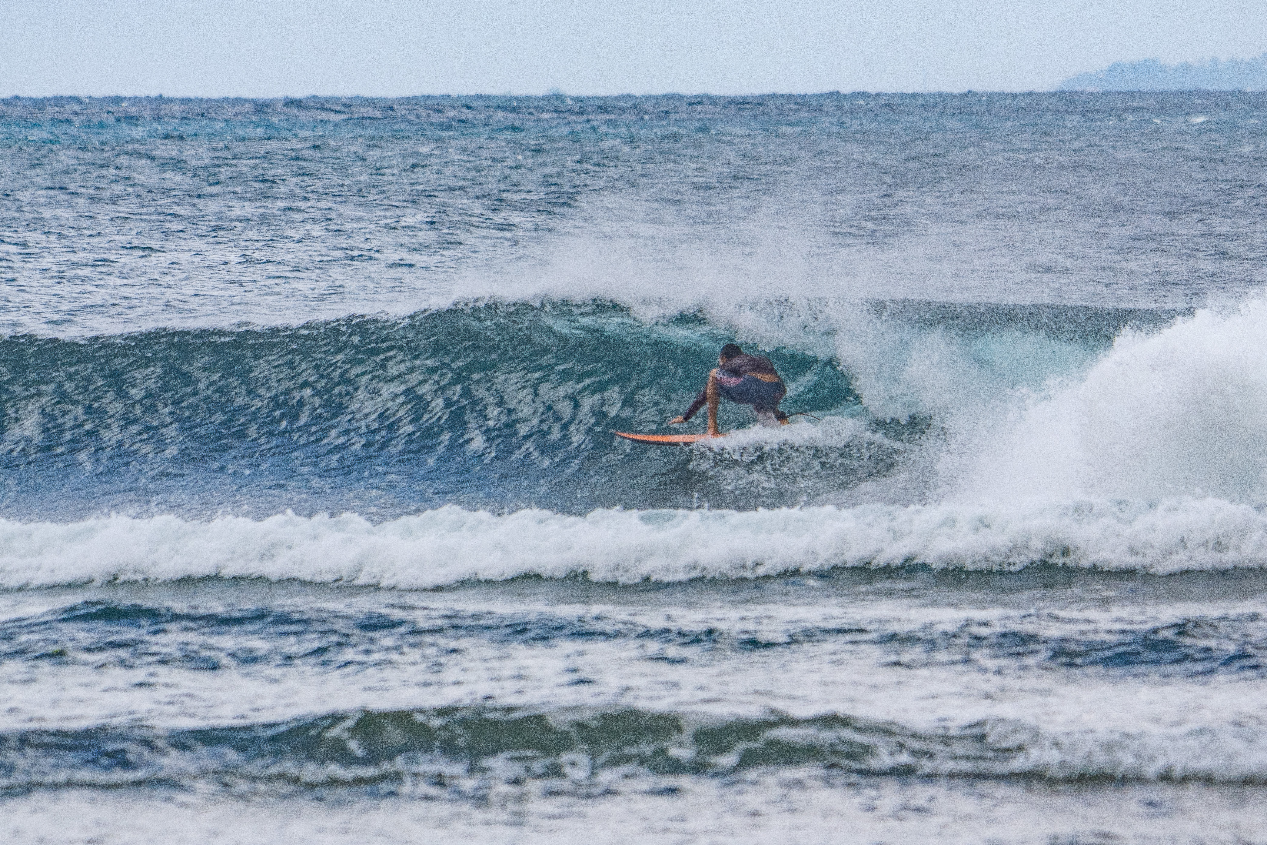 Surfer tucking into a barrel at Mushroom Rock