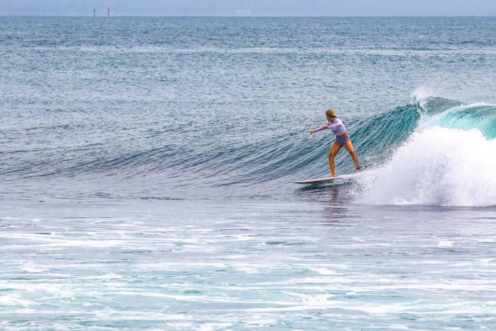 Intermediate surfer on a fun right wave at Mushroom Rock.