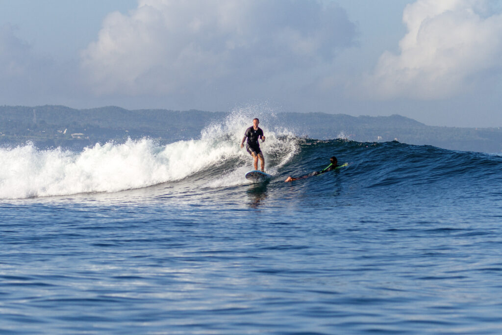 Surfer riding a small wave at Airport Left.