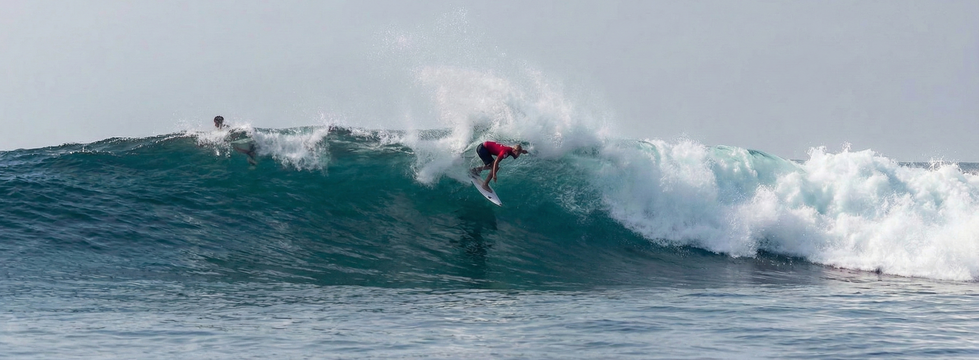 Surfer doing a backside snap at Hyatt Reef.