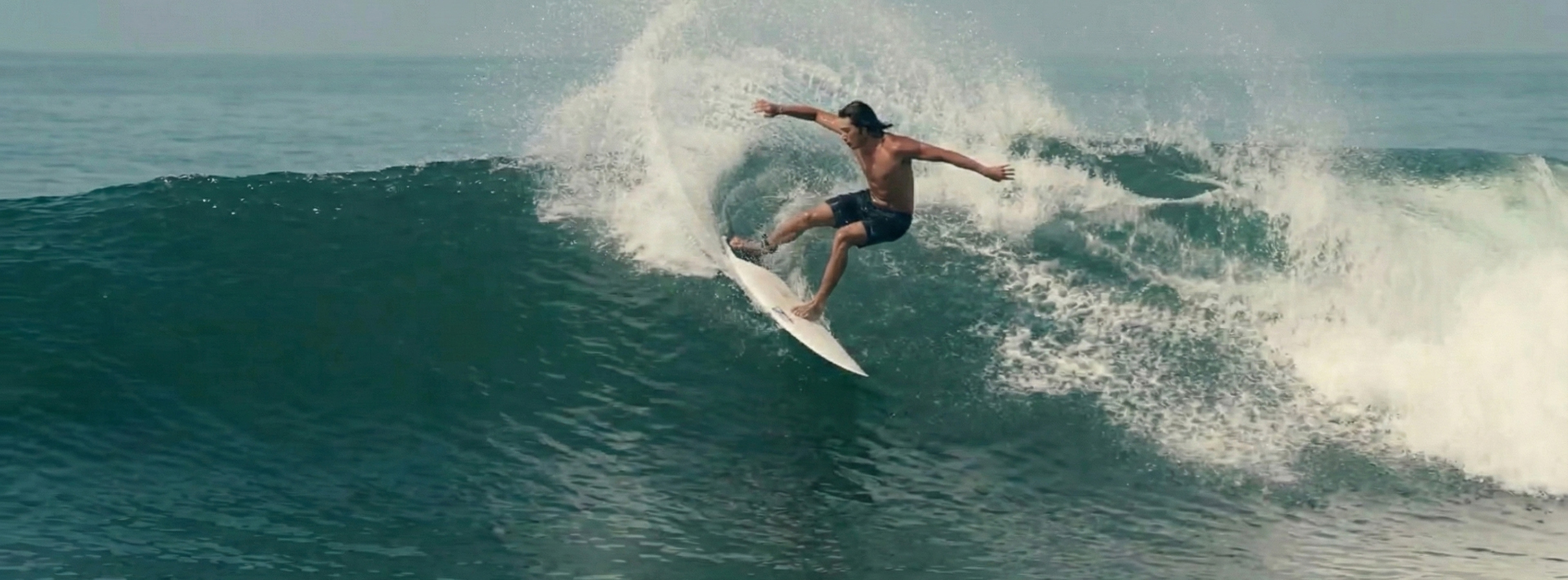 Surfer going right on a wave at Ketewel.