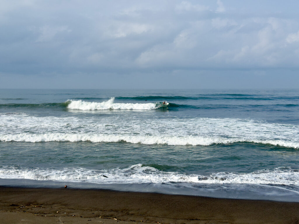 Surfer riding a wave at Pig Stone