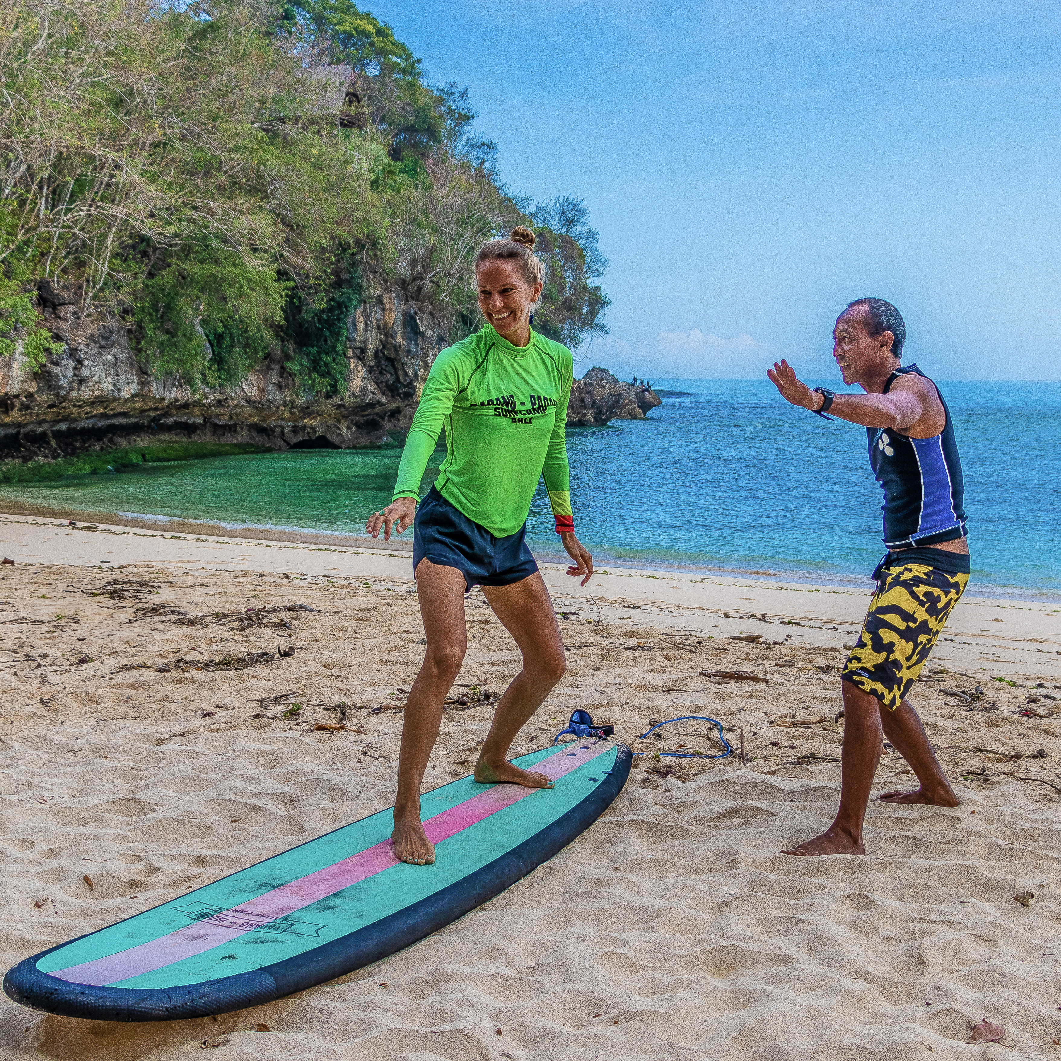 Surfing manager Richie giving a student training on the beach